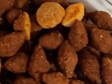 Mini kibes com bolinhas por cima, numa marmita de isopor